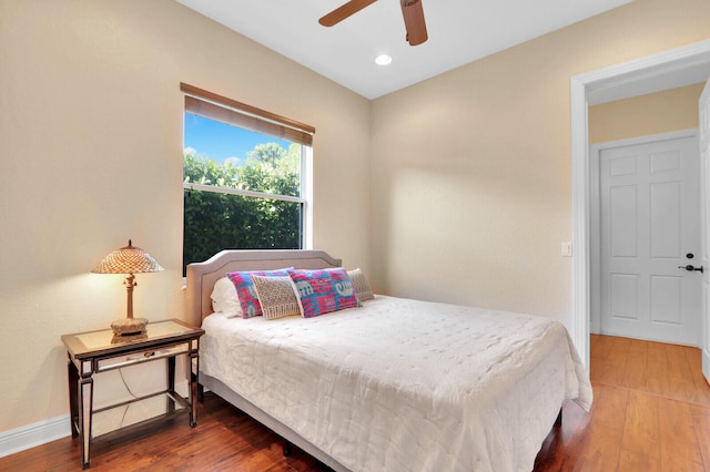 bedroom with hardwood / wood-style floors and ceiling fan