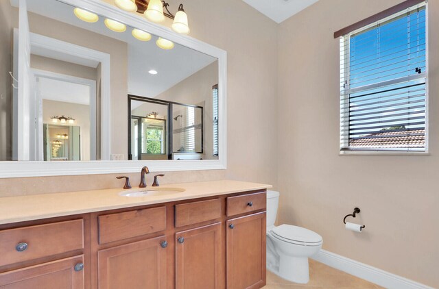 bathroom with a shower with door, vanity, toilet, and tile patterned floors