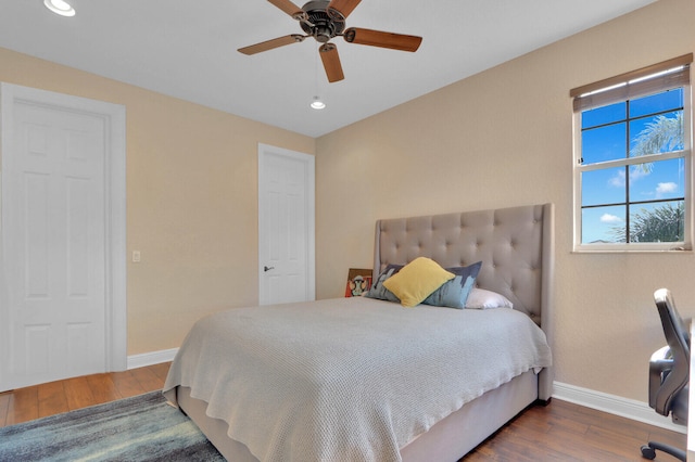 bedroom featuring ceiling fan and dark hardwood / wood-style flooring