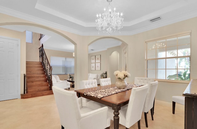 dining area featuring ornamental molding and a tray ceiling