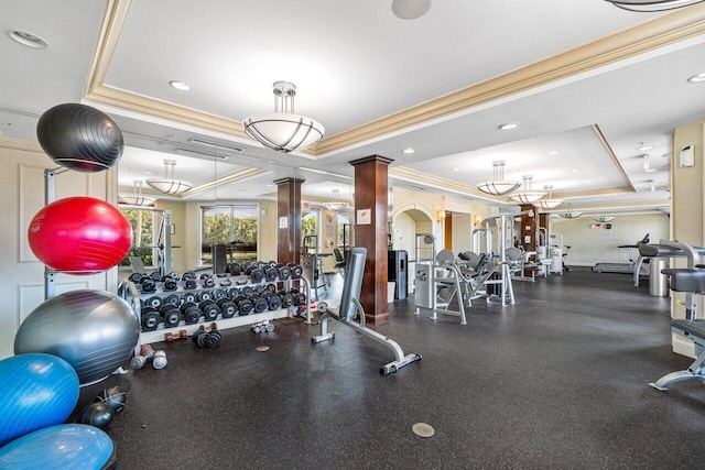 exercise room featuring ornamental molding and a raised ceiling