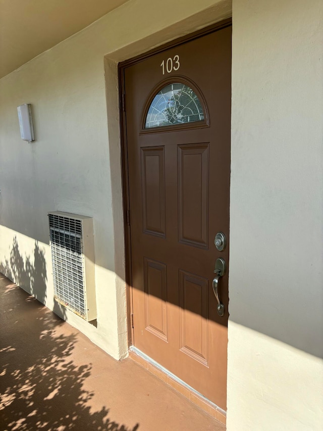 doorway to property featuring heating unit