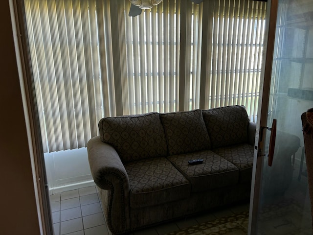 tiled living room featuring a healthy amount of sunlight and ceiling fan