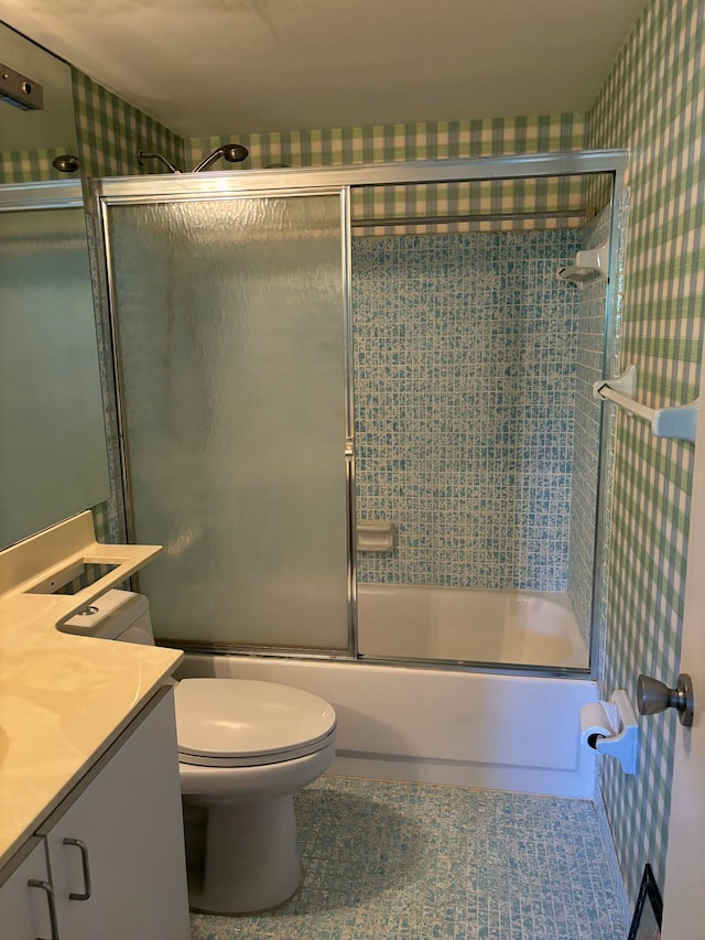 full bathroom with vanity, enclosed tub / shower combo, and toilet