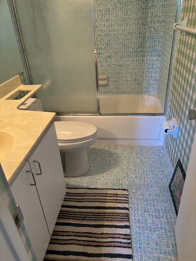 full bathroom with vanity, toilet, and combined bath / shower with glass door