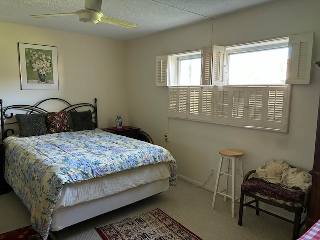 carpeted bedroom with a textured ceiling and ceiling fan