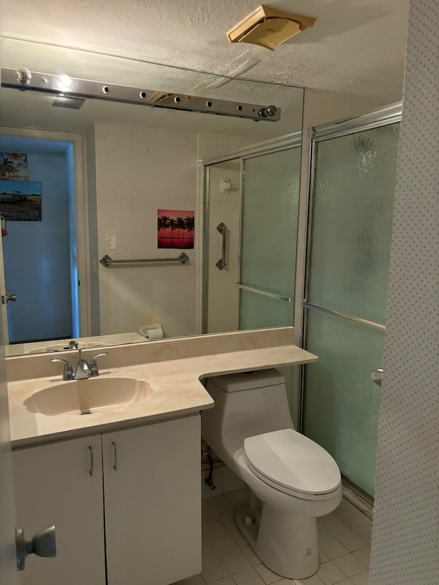 bathroom with toilet, walk in shower, and vanity