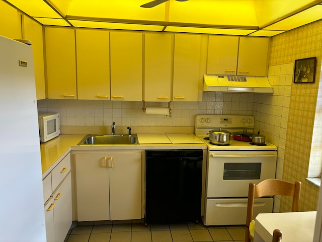 kitchen with decorative backsplash, sink, light tile patterned floors, and white appliances