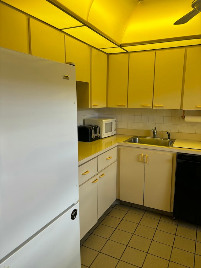 kitchen featuring white appliances, ceiling fan, tasteful backsplash, and sink