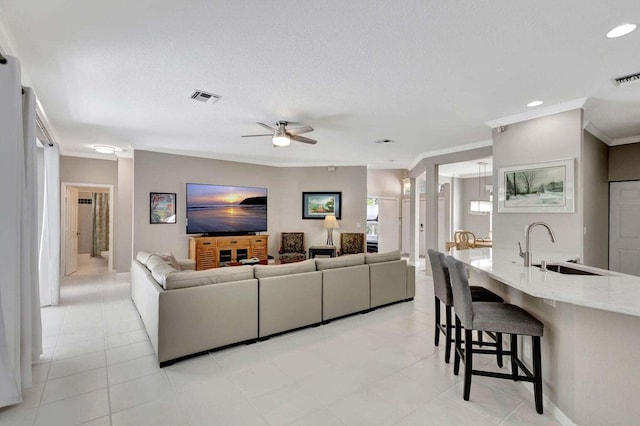 120 Jones Creek Dr, Jupiter, FL 33458 - living area with crown molding, ceiling fan, visible vents, and light tile patterned floors