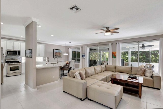 120 Jones Creek Dr, Jupiter, FL 33458 - living area featuring crown molding, a ceiling fan, visible vents, and light tile patterned flooring