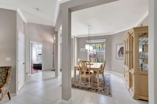 dining area with crown molding and light tile patterned floors