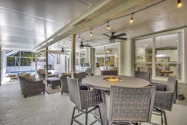 120 Jones Creek Dr, Jupiter, FL 33458 - view of patio / terrace featuring outdoor dining area, ceiling fan, a lanai, and an outdoor living space with a fire pit