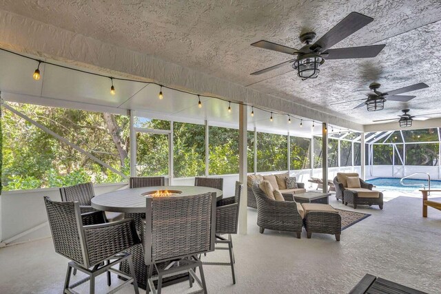 120 Jones Creek Dr, Jupiter, FL 33458 - sunroom / solarium featuring outdoor dining area, a ceiling fan, and an outdoor living space with a fire pit