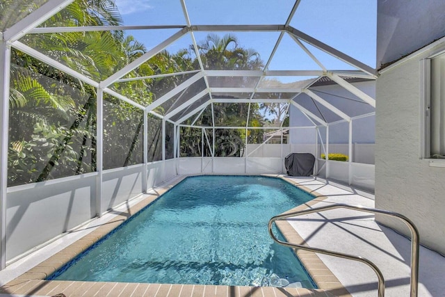 view of pool with a patio and a lanai