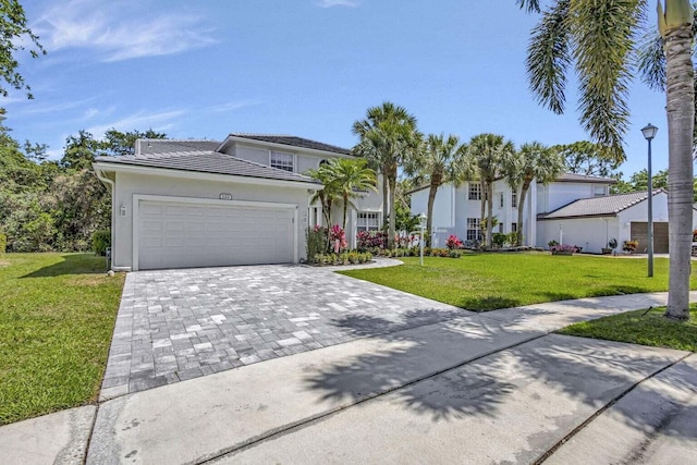 view of front of property featuring a garage and a front lawn