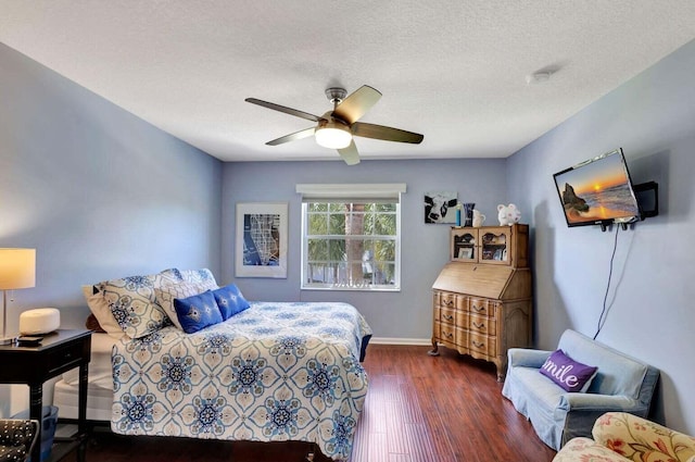 120 Jones Creek Dr, Jupiter, FL 33458 - bedroom featuring baseboards, a ceiling fan, a textured ceiling, and wood finished floors