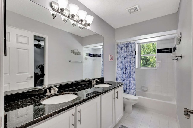 full bathroom with vanity, a textured ceiling, tile patterned floors, toilet, and shower / tub combo with curtain