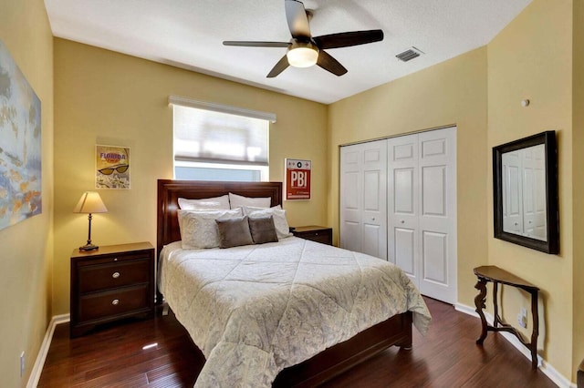 bedroom with ceiling fan, a closet, and dark wood-type flooring