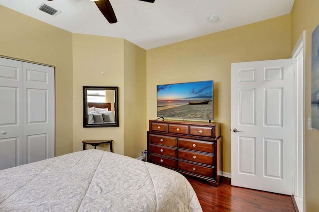 bedroom featuring ceiling fan, a closet, and dark hardwood / wood-style floors