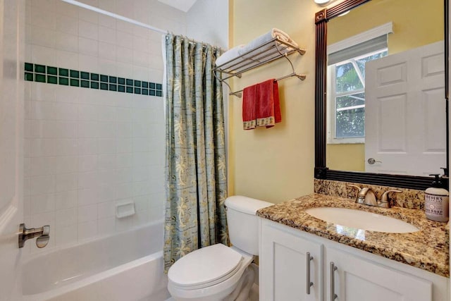 full bathroom featuring shower / bath combo, vanity, and toilet