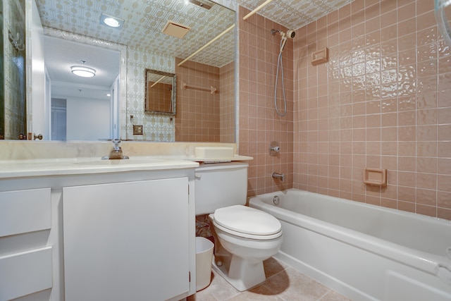 full bathroom featuring vanity, tiled shower / bath combo, toilet, and tile patterned flooring