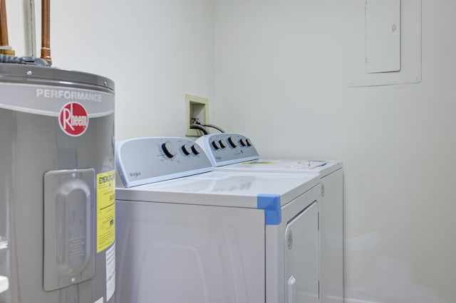 clothes washing area with water heater and independent washer and dryer