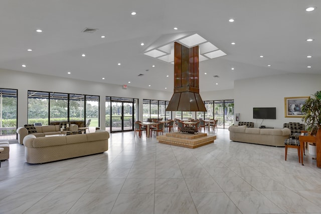 living room featuring high vaulted ceiling