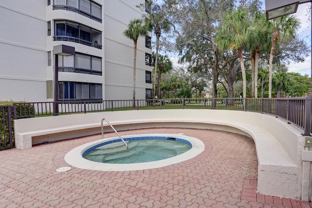 view of swimming pool featuring a community hot tub