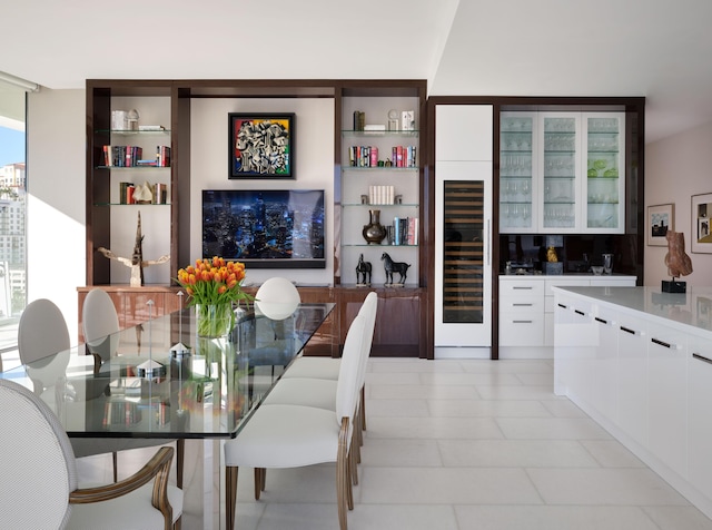 dining room with bar area, beverage cooler, and a healthy amount of sunlight