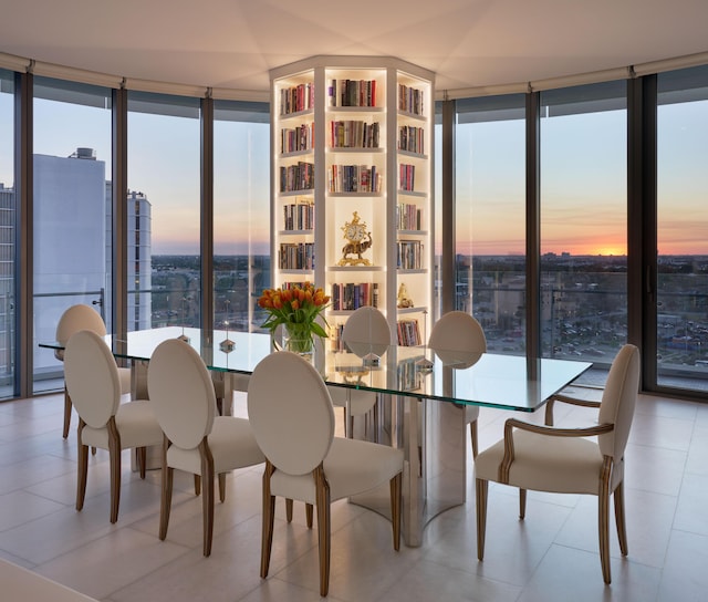 dining room featuring light tile patterned floors and floor to ceiling windows