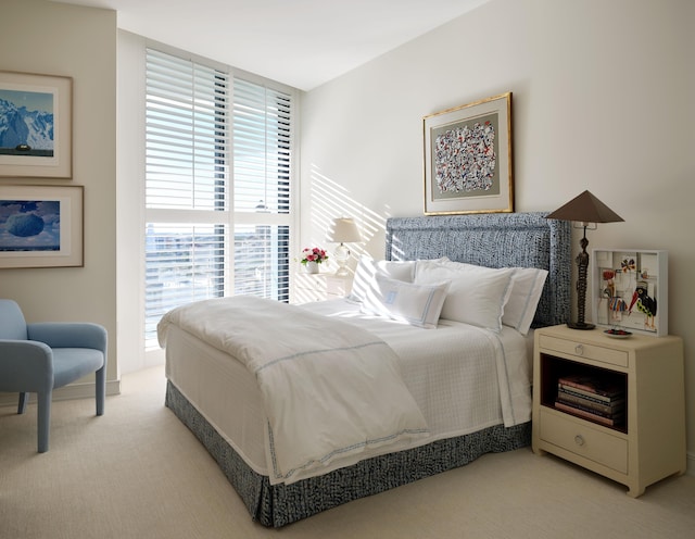 bedroom featuring light colored carpet