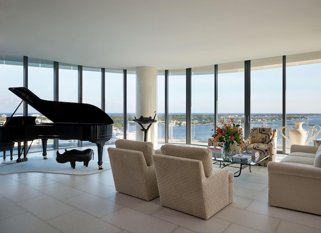 living room with expansive windows and a water view