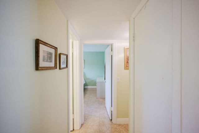 hall with light tile patterned floors