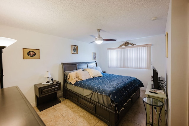 bedroom with ceiling fan, a textured ceiling, and light tile patterned floors