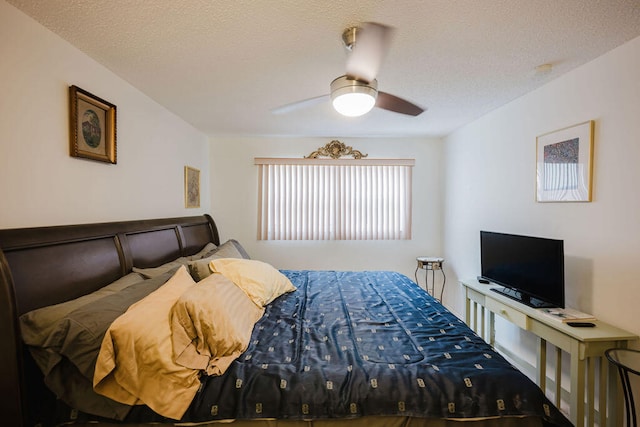 bedroom with a textured ceiling and ceiling fan