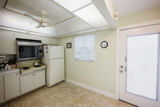 kitchen with light tile patterned flooring, ceiling fan, plenty of natural light, and white appliances