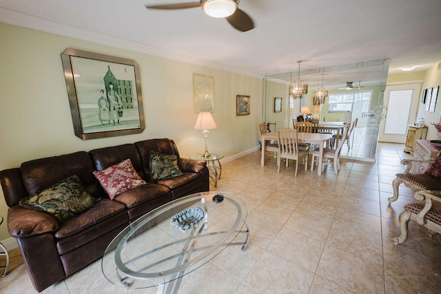 living room featuring ceiling fan, ornamental molding, and light tile patterned floors