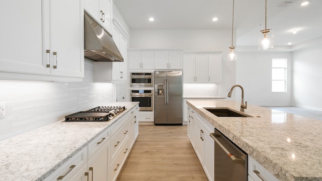 kitchen featuring light hardwood / wood-style floors, sink, hanging light fixtures, appliances with stainless steel finishes, and white cabinetry