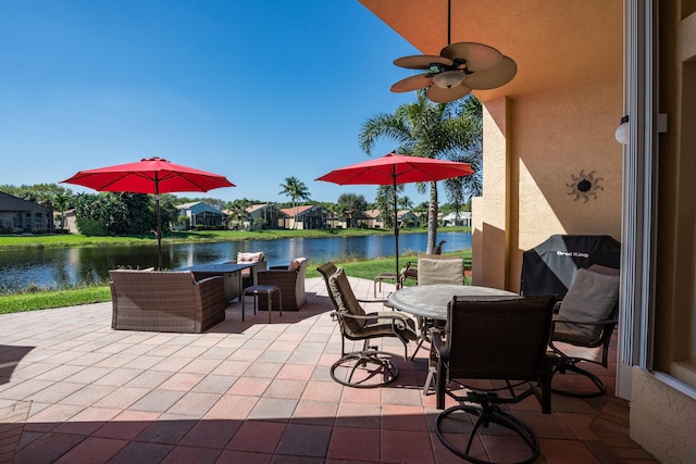 view of patio / terrace with a water view and ceiling fan