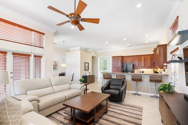 living room featuring ornamental molding, ceiling fan, and light tile patterned floors