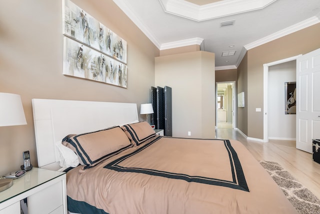 bedroom with light wood-type flooring and ornamental molding