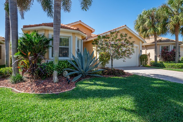 mediterranean / spanish-style house featuring a front lawn and a garage