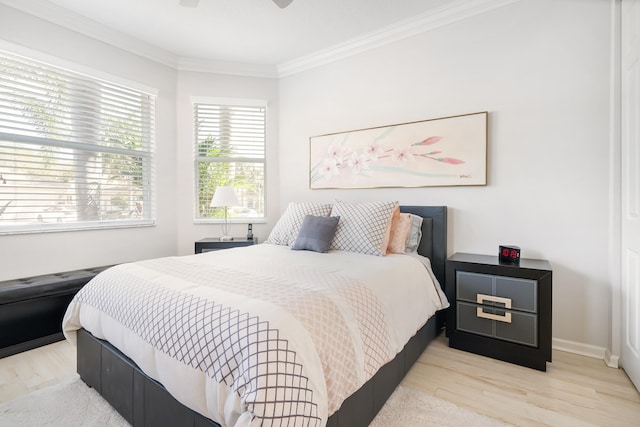 bedroom with ceiling fan, light hardwood / wood-style flooring, and ornamental molding