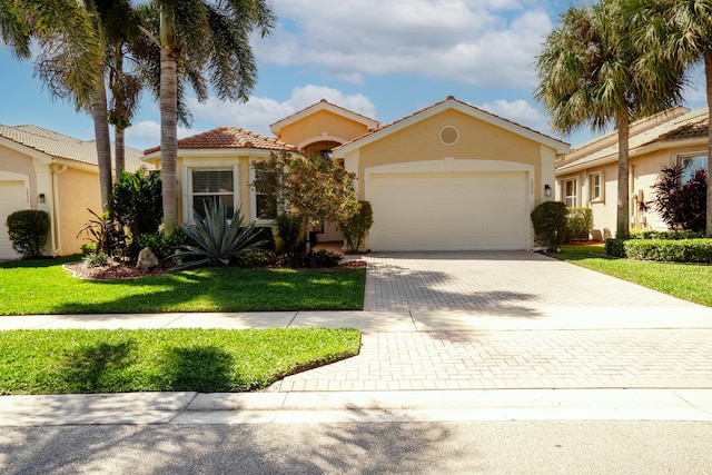 view of front facade with a garage and a front yard