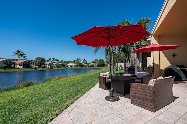 view of patio / terrace with a water view and grilling area