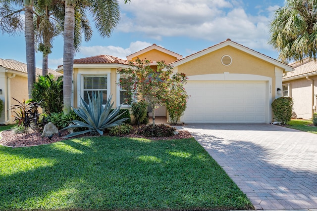 view of front of property featuring a front yard and a garage