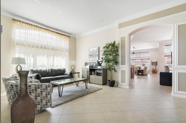 tiled living room featuring crown molding and a wealth of natural light