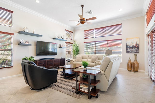 living room with light tile patterned flooring, crown molding, and a wealth of natural light