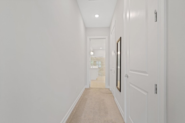 hall with light colored carpet